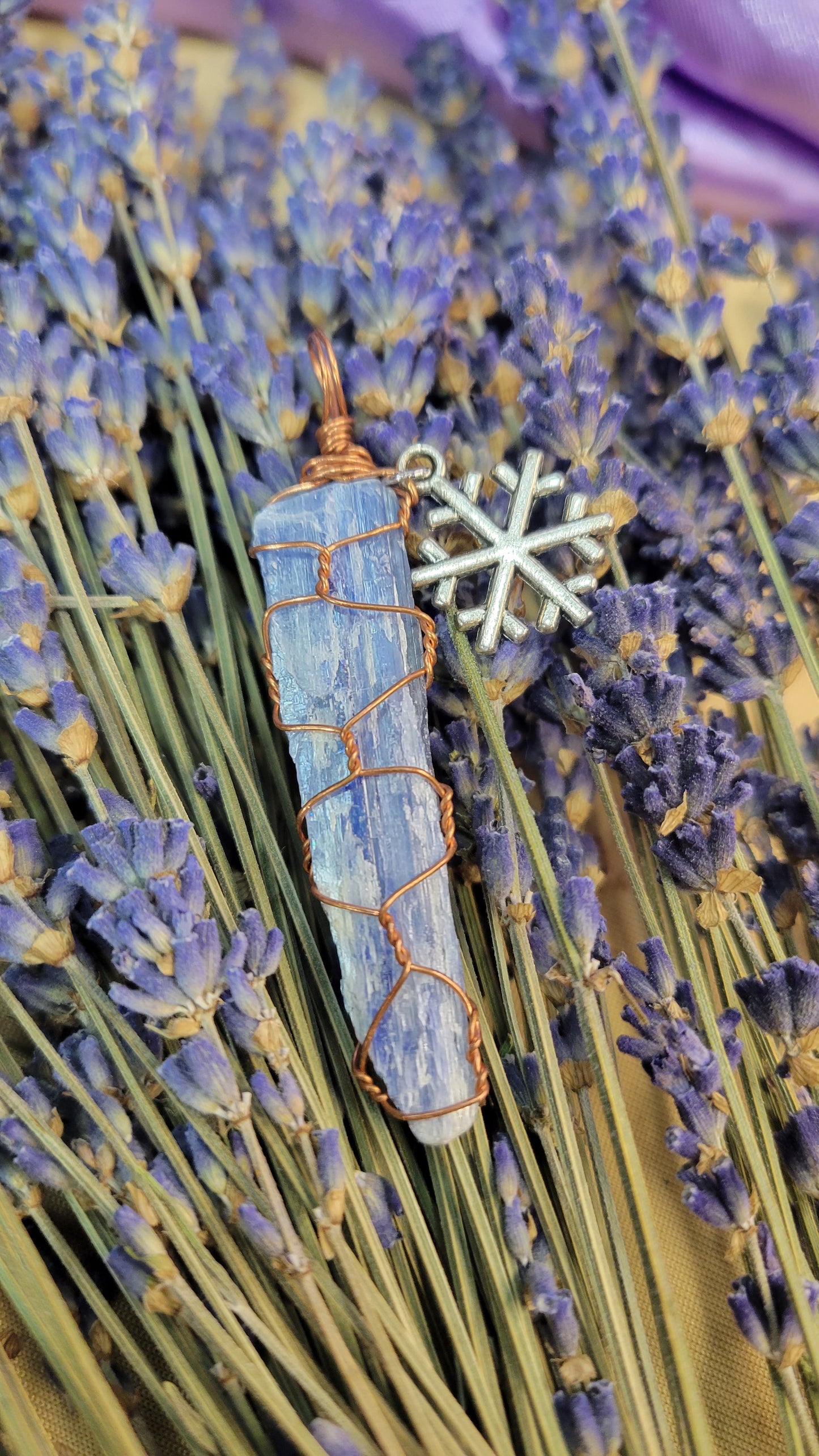 Wire wrapped blue kyanite crystal necklace with snowflake charm